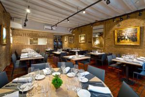 a dining room with tables and chairs with wine glasses at Casa OTANO in Pamplona