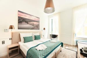 a bedroom with a bed and a painting on the wall at Boutique Residence Budapest in Budapest +34 photos
