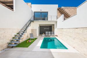 a house with a swimming pool and stairs at Ca Na Foc in Sa Pobla