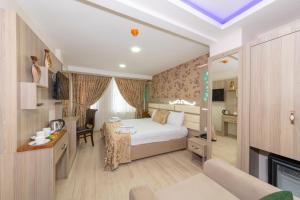 Un pat sau paturi într-o cameră la Raimond Hotel