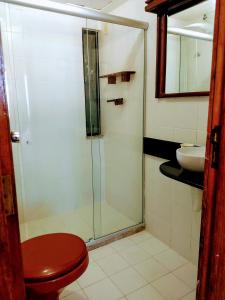 a bathroom with a shower and a toilet and a sink at Flat Barra in Salvador