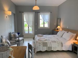 a bedroom with a bed and a table and chairs at Kiki Studios in Fiskardo