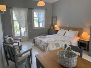 a bedroom with a bed and a table and chairs at Kiki Studios in Fiskardo