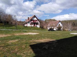 an old house on a grassy field in front at Albergue Irugoienea in Espinal-Auzperri