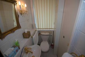 a small bathroom with a toilet and a sink at 164 Seeteufel Ferienwohnung in Wilhelmshaven +20 photos