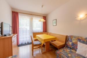 a small living room with a table and a couch at Residence Trenker Luis in Braies