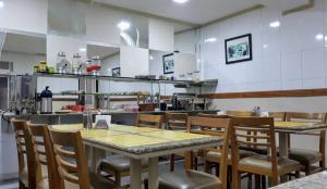 a restaurant with tables and chairs in a kitchen at Hotel Único in Rio de Janeiro