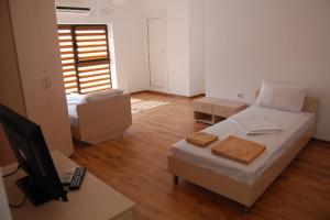 a bedroom with a bed and a desk with a computer at The White House in Karlovo