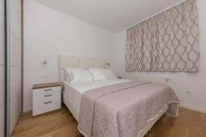 Postel nebo postele na pokoji v ubytování Penthouse Jure