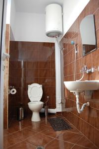 a bathroom with a toilet and a sink at The White House in Karlovo