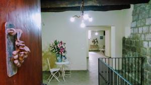 a hallway with a table and chairs in a building at La Quercia di Aorivola in Caianello Vecchio