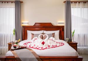 a bedroom with a bed with a heart decoration on it at Mony Reach Angkor Hotel in Siem Reap
