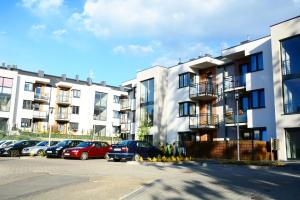 a parking lot with cars parked in front of buildings at Apartament Champion in Gorzów Wielkopolski