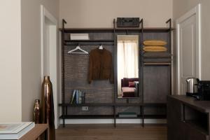 a room with a shelf with a jacket on it at Della Spiga Suites by Brera Apartments in Milan