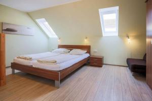 a bedroom with a large bed and a window at Buedlfarm-Scheune in Sahrensdorf