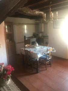 a kitchen with a table and chairs in a room at CASA RURAL LA TEYERUCA in Llanes