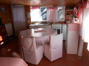 a small kitchen with a table and a sink at OLD FARM HOUSE in Riomaggiore