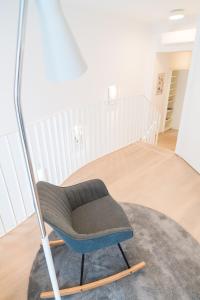 a chair in a living room with a rug at Luxury Suites Liechtenstein in Vienna