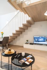 a living room with a staircase and a coffee table at Luxury Suites Liechtenstein in Vienna