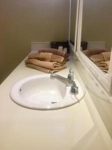 a bathroom with a white sink and a mirror at Skyline Suite in Playa del Carmen