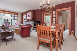 a dining room and living room with a table and chairs at Village 1402 in Mammoth Lakes