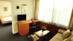 a living room with a desk and a couch at Bürgerhaus in Steinbach im Taunus