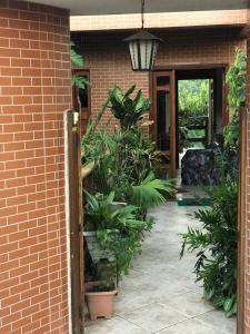 an open door to a brick building with plants at Pousada Sereia Dourada in Itacaré