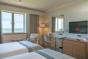 a hotel room with two beds and a flat screen tv at Portmarnock Resort & Jameson Golf Links in Portmarnock