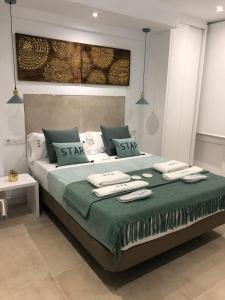 a bedroom with a large bed with towels on it at EVE Malagueta in Málaga