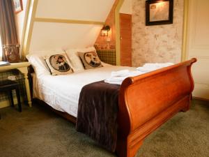 a bedroom with a bed with two dogs on the pillows at Hotel Pegasus in Apeldoorn