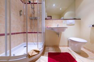 a bathroom with a shower and a toilet and a sink at Urban Style hotel de l'Europe in Rouen