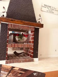 a brick fireplace with a christmasreath on it at Hotel Portinari in Porto