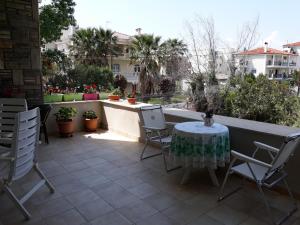 a table and chairs sitting on a patio at Maisonette Afroditi in Perea