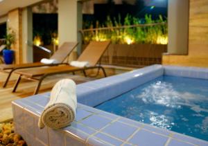 a towel laying on the edge of a swimming pool at Enjoy Olímpia Park Resort in Olímpia