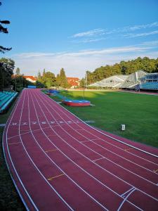 a red race track with a stadium in the background at hostel leśny in Sopot