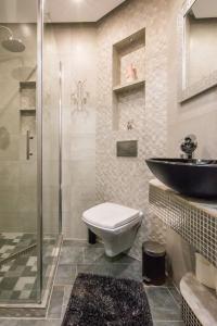 a bathroom with a sink and a toilet and a shower at Apartament LUX in Karpacz
