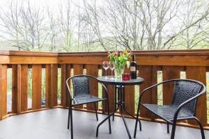 a patio table with two chairs and a bottle of wine at Apartament LUX in Karpacz +2 photos