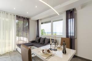 a living room with a couch and a table at Villa Linda in Crikvenica