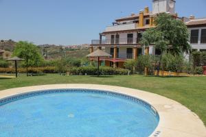 a large swimming pool in front of a house at HAA001) Apartamento moderno con jardín. in Ayamonte