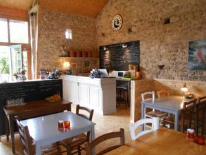 a restaurant with tables and chairs and a counter at Yourtes de Vassivière in Peyrat-le-Château