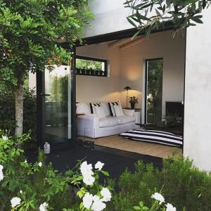 a living room with a white couch on a patio at Quinta da Lua in Tavira