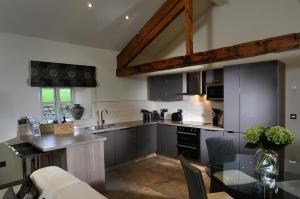 a kitchen with a table and a counter top at Contemporary Barn Conversion in Stunning Setting in Kirkby Lonsdale