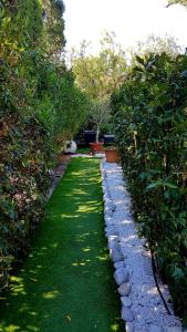 a garden with a row of rocks and plants at Le Mas de Marie in Grimaud