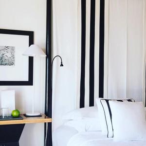 a bedroom with a bed and a desk with a lamp at Quinta da Lua in Tavira