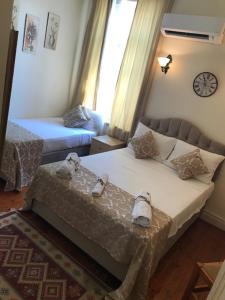 a hotel room with two beds and a window at Deniz Konak Boutique Hotel in Kyrenia