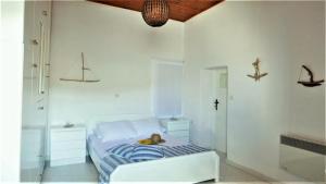 a bedroom with a bed with a stuffed animal on it at Stella's Home in Koronos in Kóronos