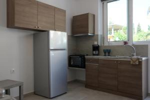 a kitchen with a white refrigerator and a microwave at Iconic Chania in Chania
