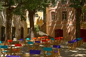 
a row of tables with chairs and umbrellas at Villa Termal Monchique - Hotel Central - by Unlock Hotels in Monchique
