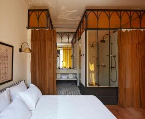 a hotel room with a bed and a dresser at Cocorico Luxury Guest House in Porto