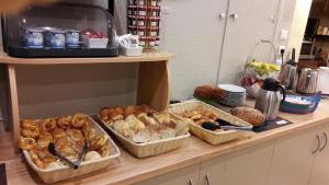 a counter with several baskets of bread and pastries at Hotel de la Plage - Barcares in Le Barcarès